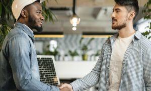 medium-shot-man-shaking-hands-indoors